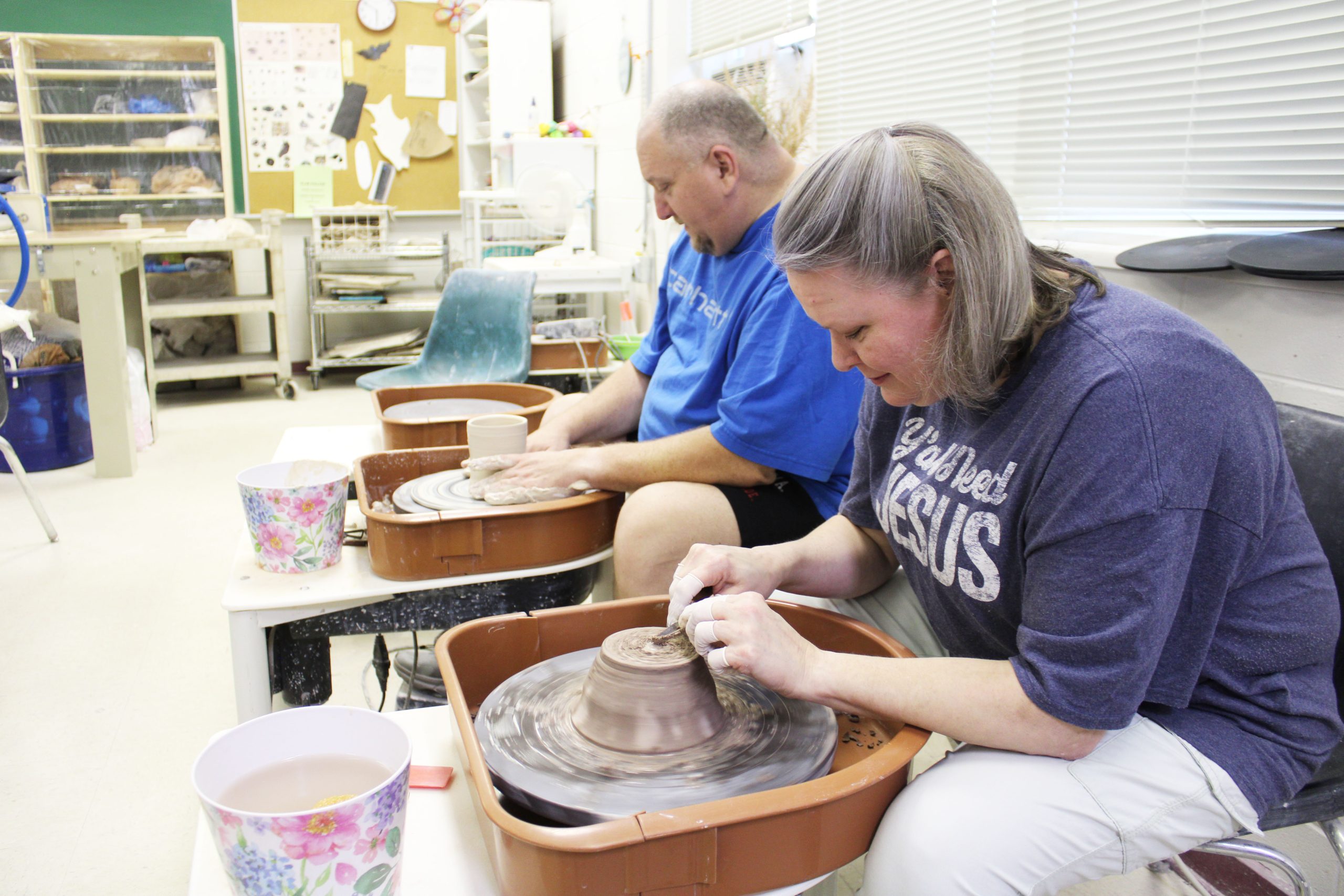 Group of people participating in pottery at the studio.