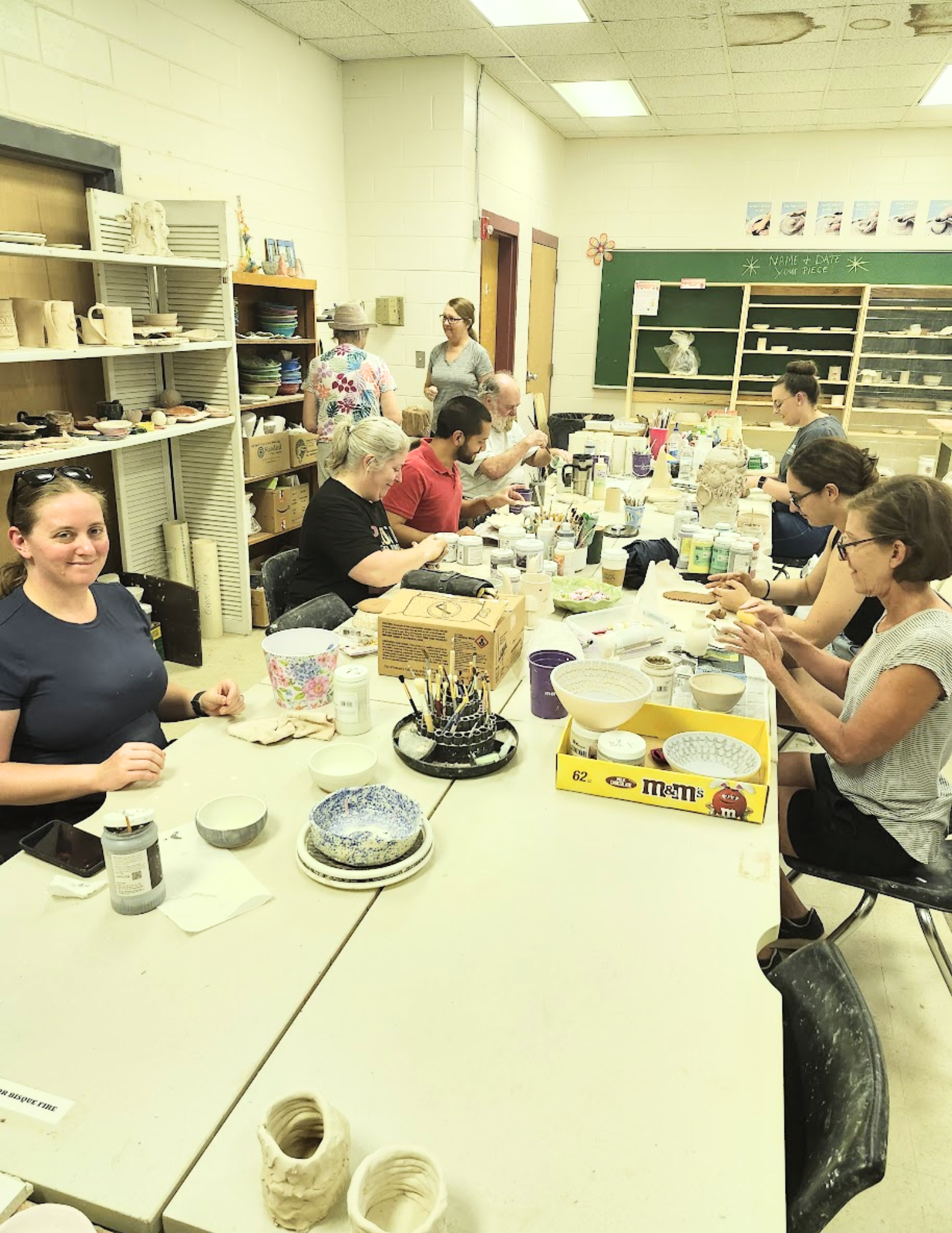 Group of people participating in pottery at the studio.